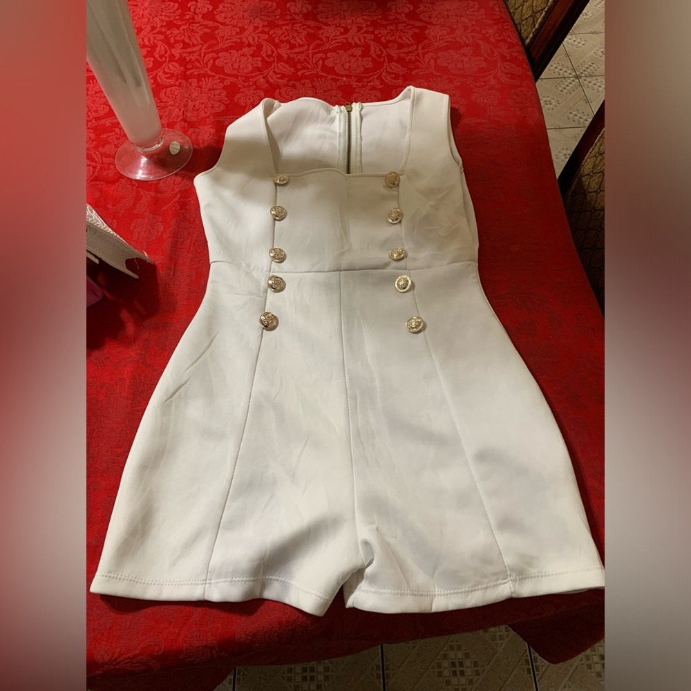 Brand new without tag white Romper with gold stylish buttons on front.